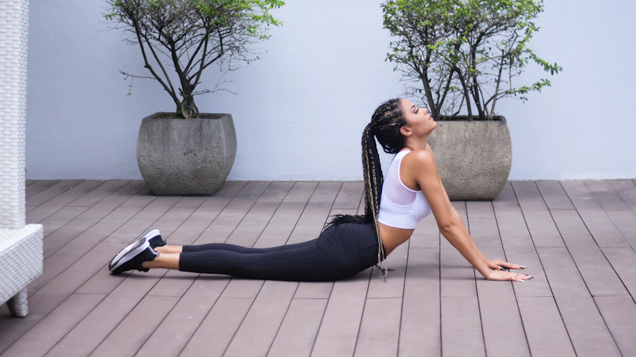 Person moving through a gentle back-extension mobility stretch on an outdoor deck